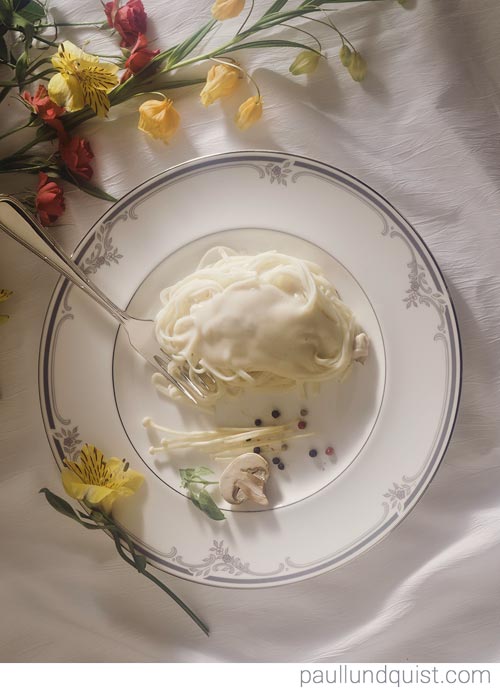 Alfredo Fettuccine On White Plate with Flowers